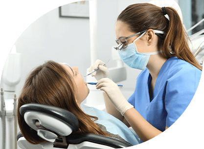 A dentist cleaning a patient’s teeth