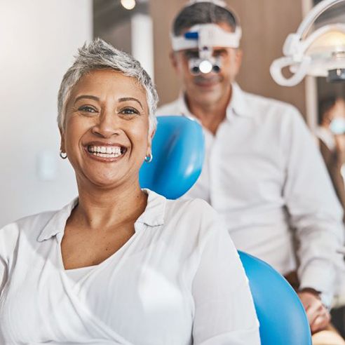 Smiling dental patient in treatment room