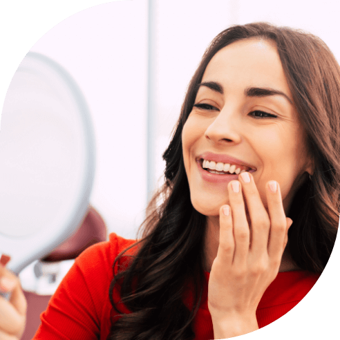 Woman smiling after tooth replacement with dental implants