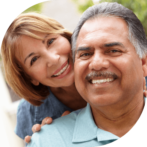 Man and woman smiling after tooth extractions