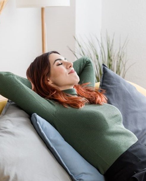 Woman resting at home on sofa