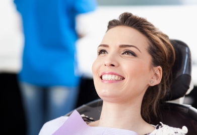 Woman smling during dental checkup and teeth cleaning visit