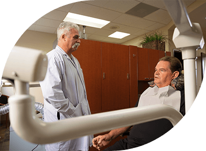 Dentist talking to dental patient during initial removal set up visit