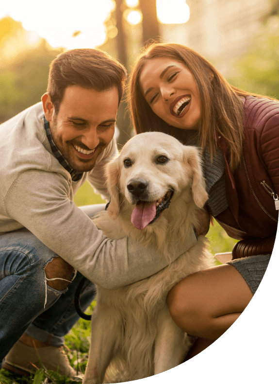 Man and woman with their dog sharing healthy smiles