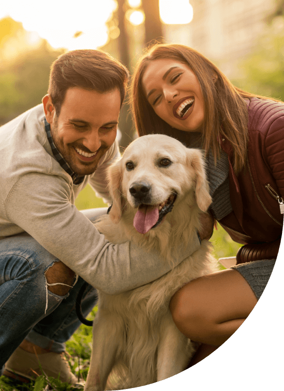 Man and woman with their dog sharing healthy smiles after receiving dental services in Albuquerque New Mexico