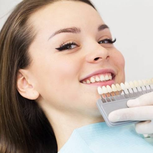 a patient smiling as they receive veneers in Albuquerque, NM