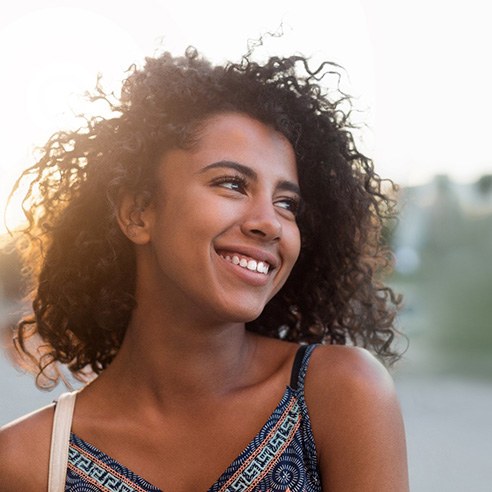 Woman outside smiling with veneers in Albuquerque, NM