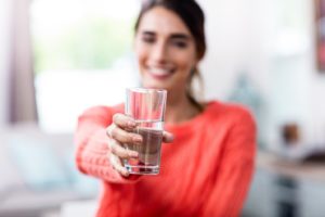 Woman enjoying water as part of her new health plan