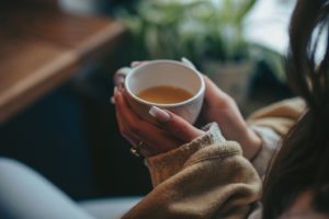 Woman drinking tea in order to prevent cavities