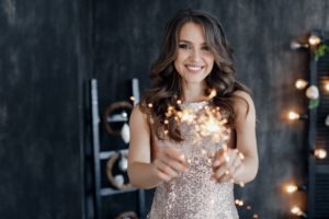 woman smiling happily for New Year’s Eve