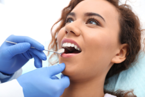 a patient smiling and visiting her dentist for a tooth-colored filling